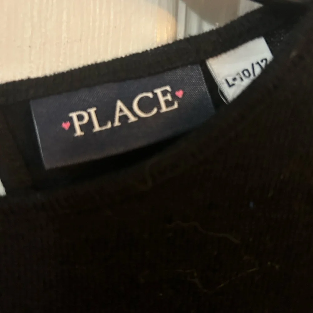 The children’s place black sweater with sequins stars.